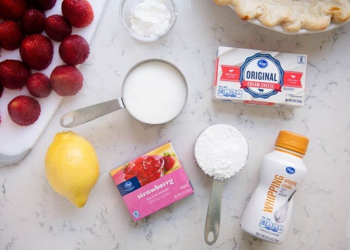 Ingredients for strawberry pie on counter. 