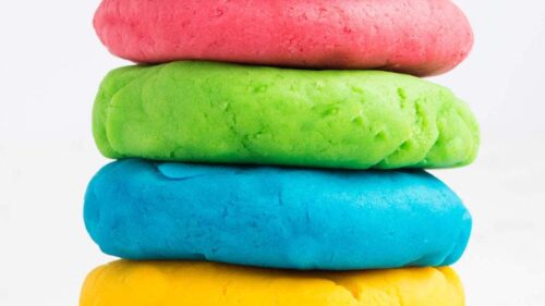 rainbow colored play dough stacked on top of each other