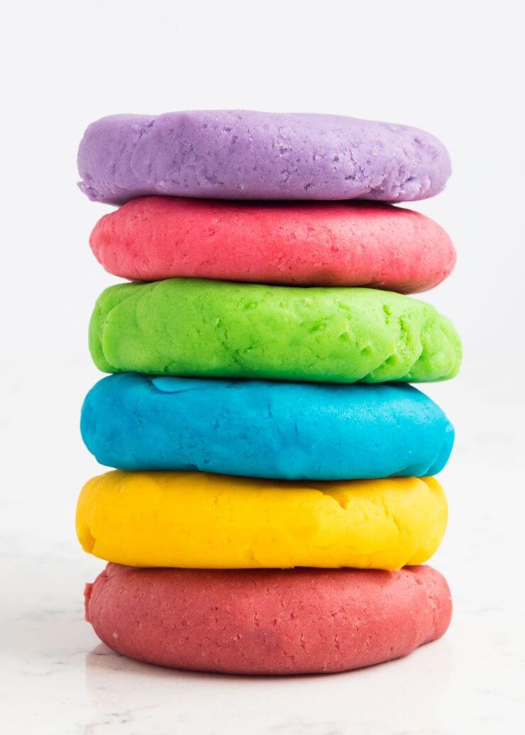 The BEST homemade playdough recipe - make in less than 5 minutes for under a $1 and have it last for months! It is so soft and squishy and cuts perfectly with cookie cutters.