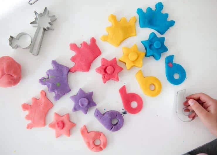 cutting out play dough with cookie cutters 