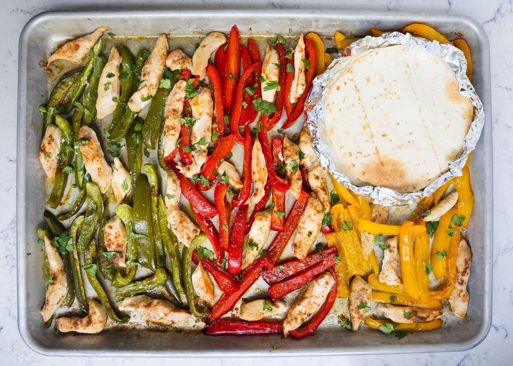 Sheet pan fajitas on a baking sheet.