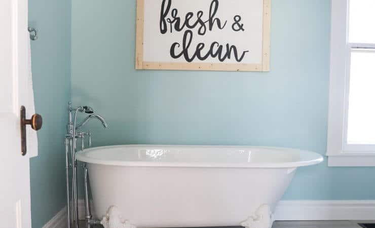 Fixer Upper Bathroom Before and Afters... fixer upper style bathroom makeover with clawfoot tub, watery paint color and sliding bar door. Clean, fresh, and airy bathroom!