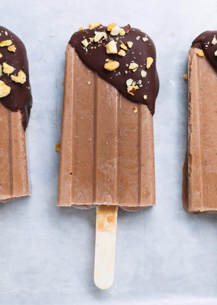 Fudge popsicles dipped in chocolate and crushed nuts.