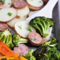 roasted sausage and veggies on a wooden spoon