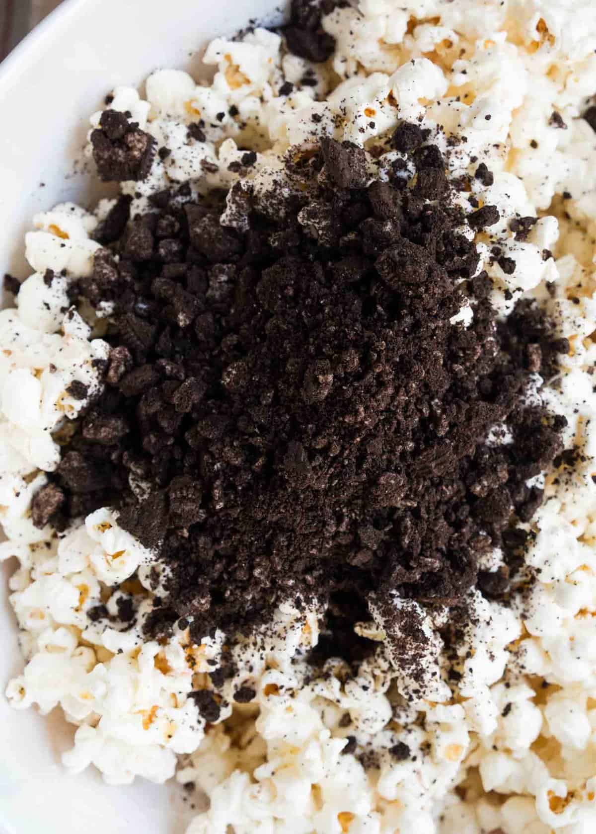 Crushed Oreos on top of white chocolate popcorn.