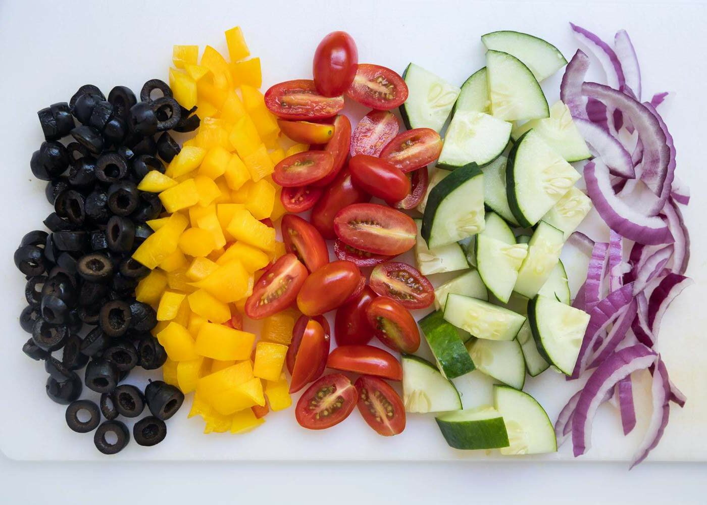 Chopped vegetables on cutting board .