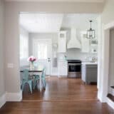 a kitchen with a table and hardwood floors