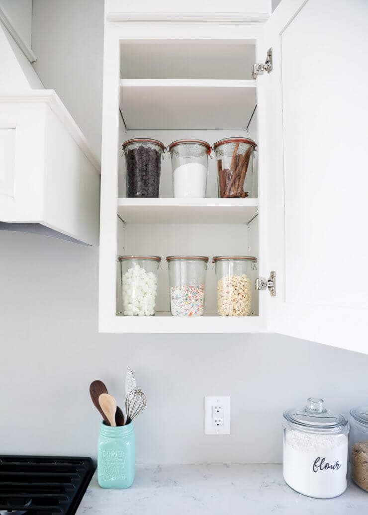 glass food storage containers in an open cabinet 