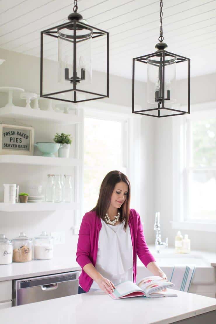 A woman standing in front of a window in the kitchen 