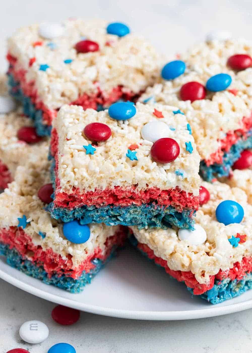 4th of july rice krispie treats stacked on a white plate.