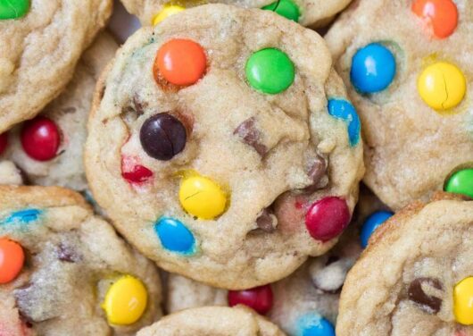 A close up of a pile of M&M cookies
