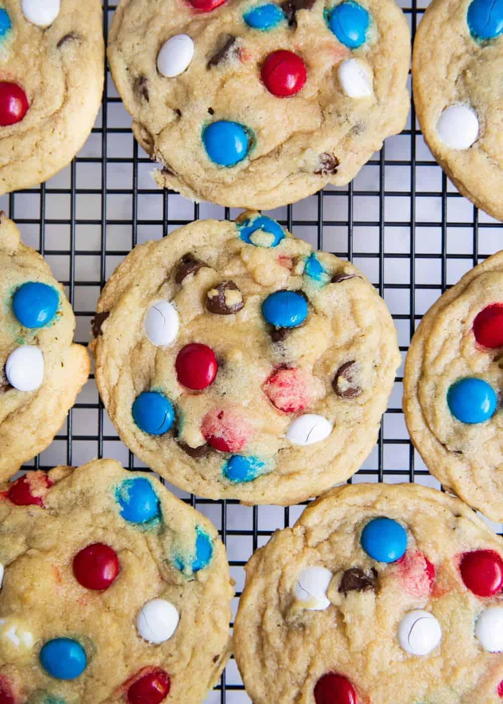 red, white and blue M&M cookies on baking rack