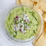 bowl of guacamole with tortilla chips