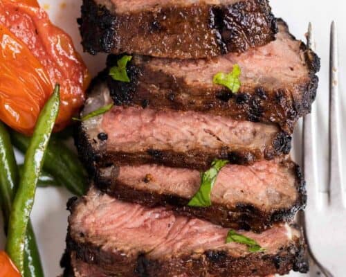 sliced grilled steak on a plate