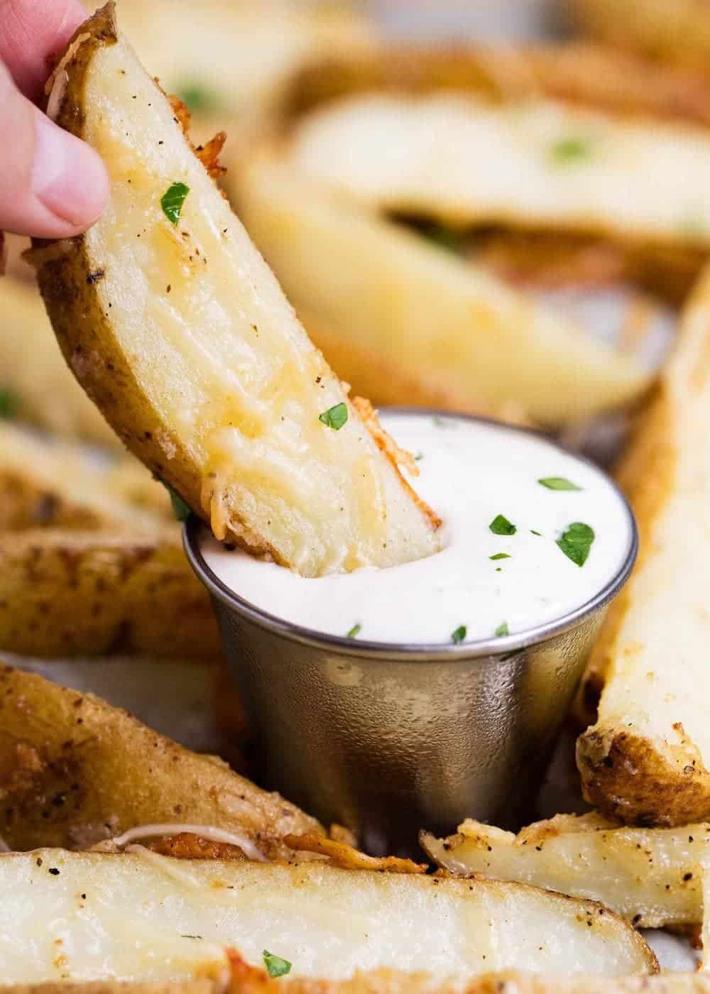 Dipping parmesan potato wedge into ranch.