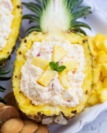 pineapple fluff served in a fresh pineapple boat