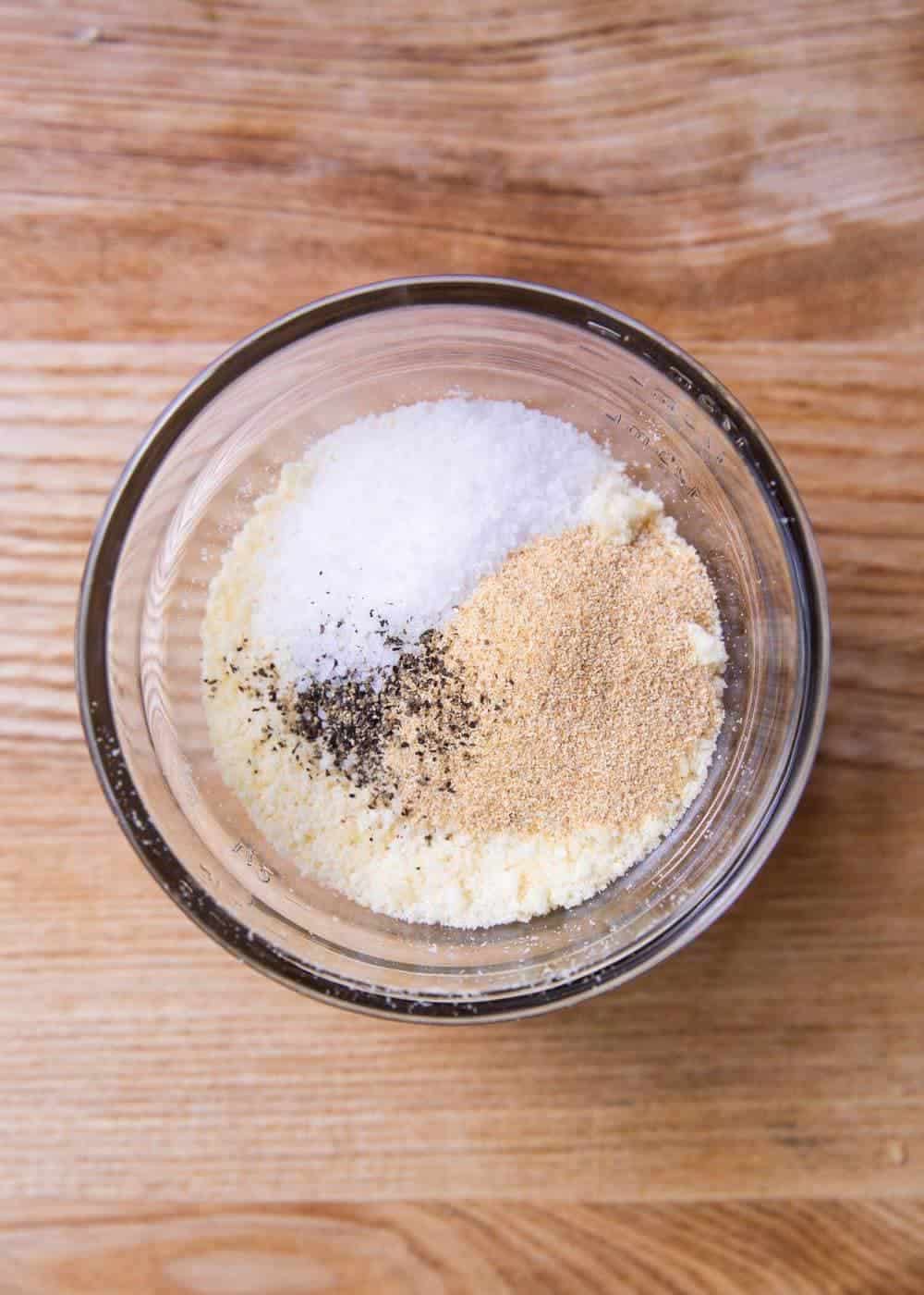 Seasoning for zucchini fries in a glass bowl.