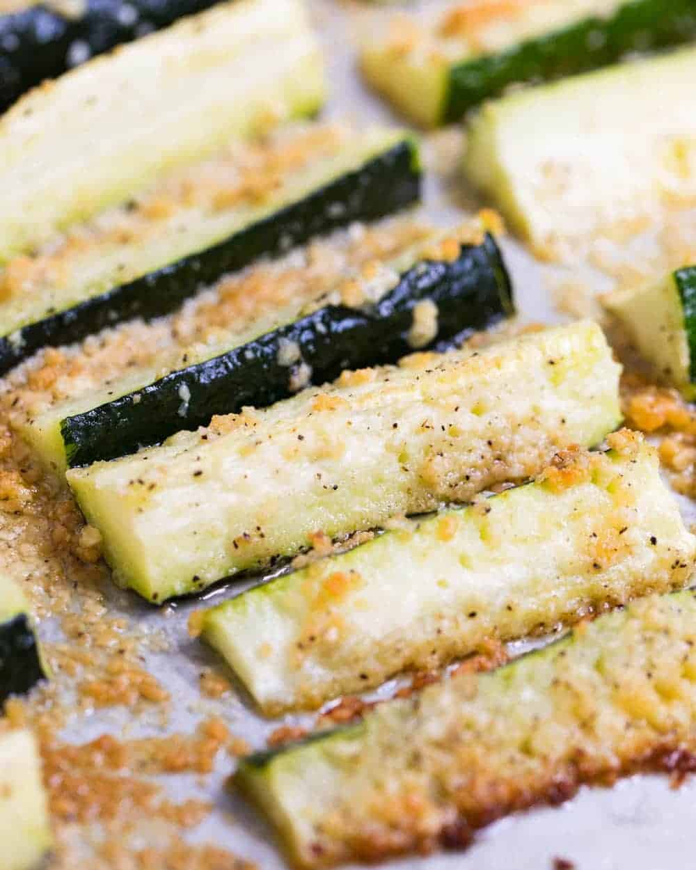 A close up of baked parmesan zucchini fries.