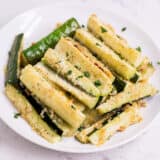 parmesan zucchini fries on a white plate