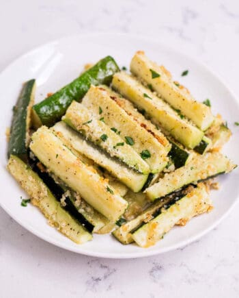 parmesan zucchini fries on a white plate