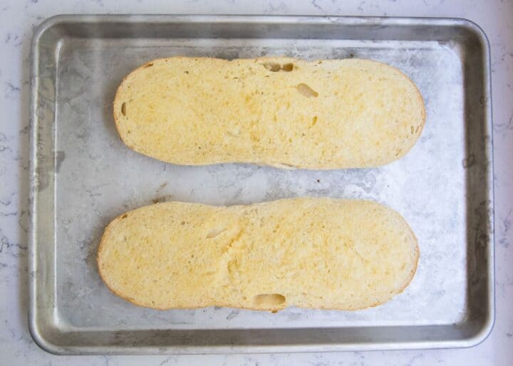 garlic french bread loafs on baking sheet 