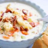 A close up of a bowl of roasted cauliflower soup