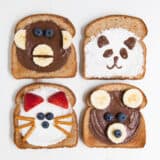 4 pieces of toast decorated to look like animal faces