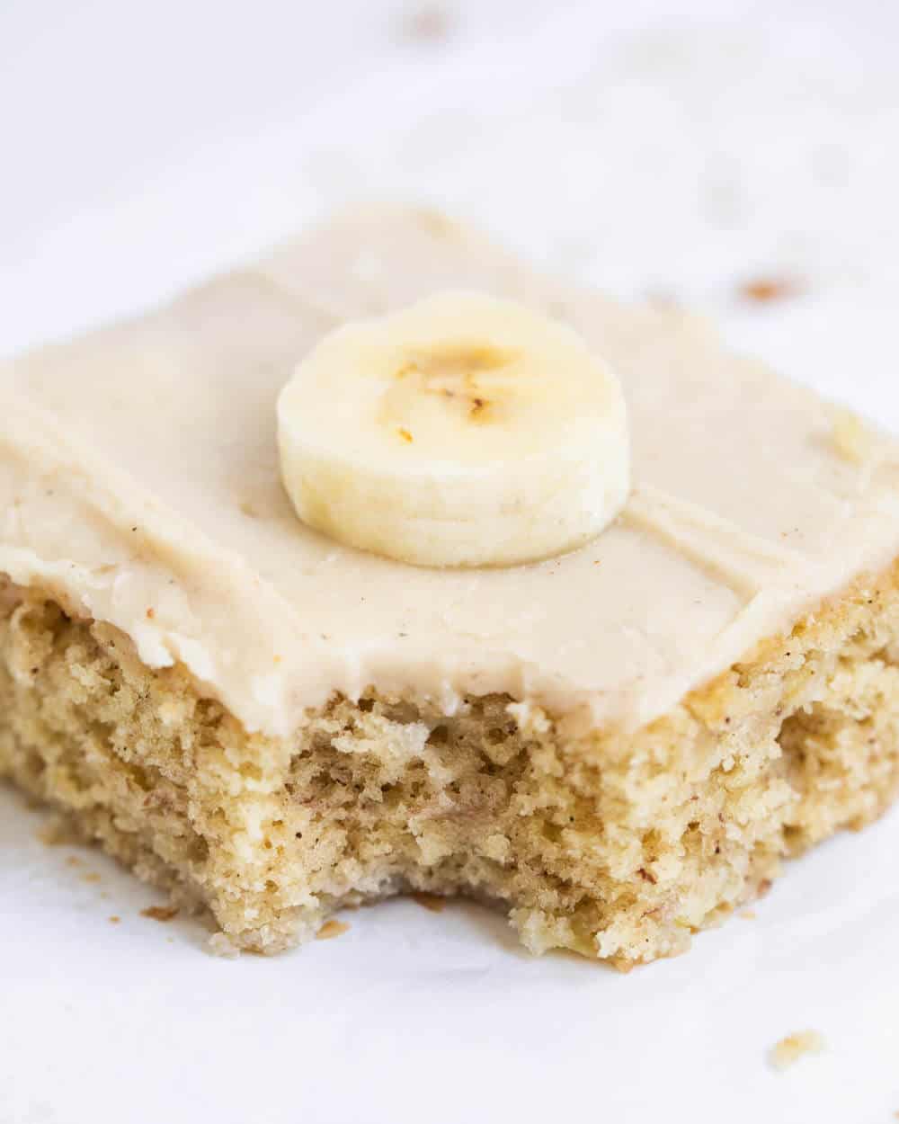 Frosted banana bar with a bite taken out.