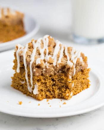 A piece of pumpkin coffee cake on a white plate