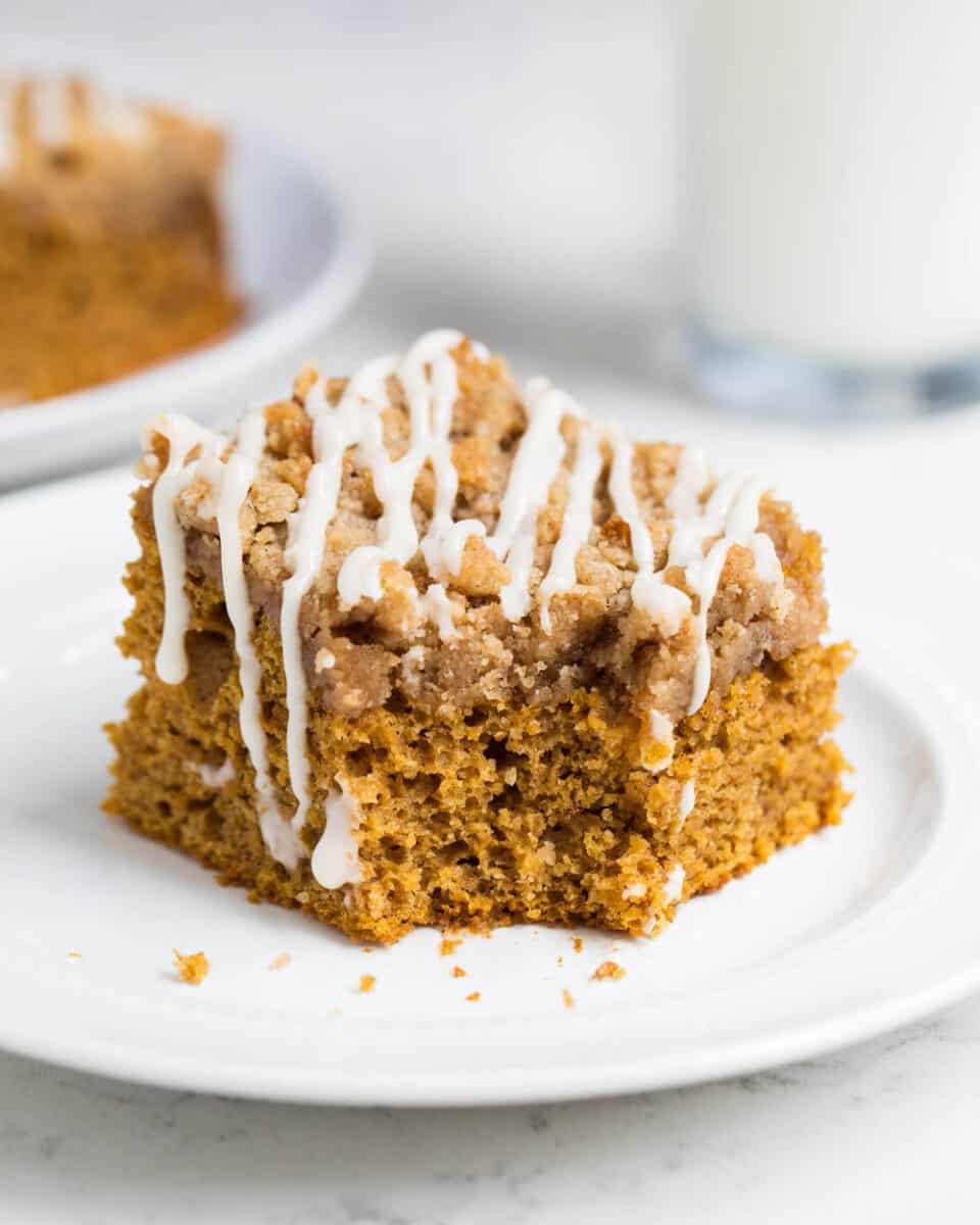 A piece of pumpkin coffee cake on a white plate 