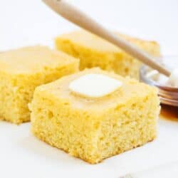 slice of sweet cornbread with butter and honey