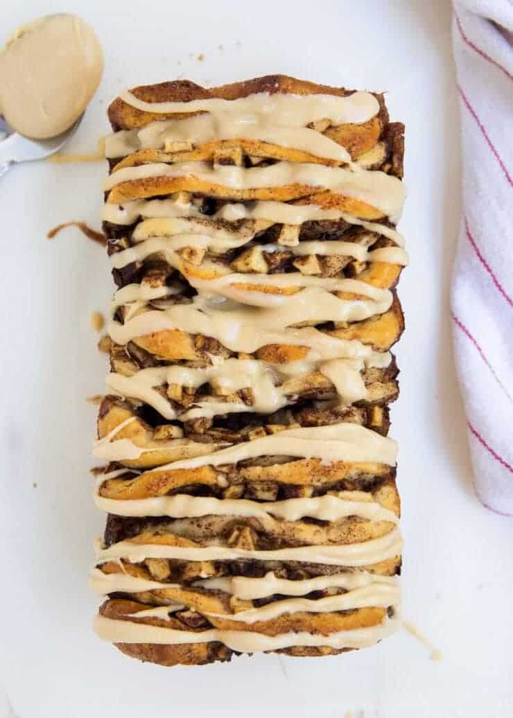 Apple pull apart bread -filled with brown sugared cinnamon apples and topped with the most amazing caramel icing. The perfect fall dessert!