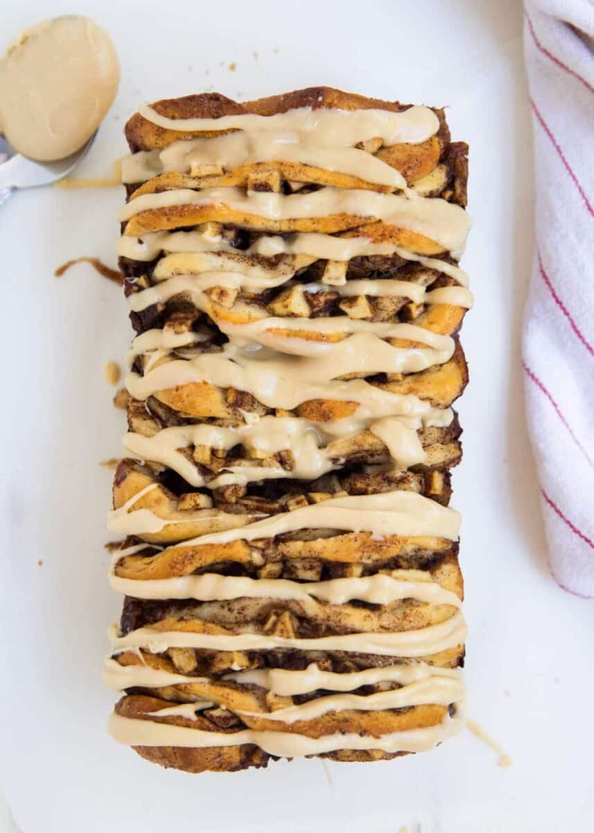loaf of apple pull apart bread with caramel glaze drizzled on top 