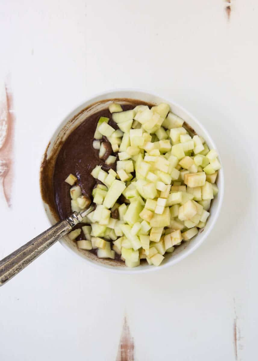 making filling in bowl with diced apples and sugar 