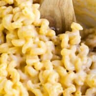 macaroni and cheese with a wooden spoon