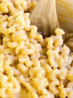 macaroni and cheese with a wooden spoon