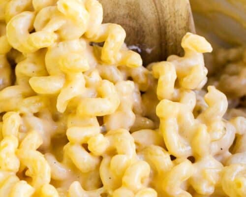macaroni and cheese with a wooden spoon