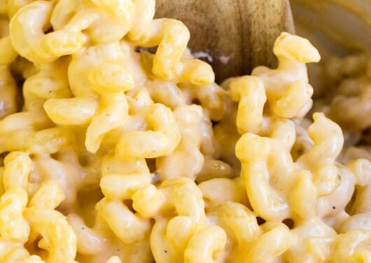 macaroni and cheese with a wooden spoon