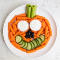 plate of veggies and dip in the shape of a pumpkin