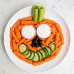 plate of veggies and dip in the shape of a pumpkin