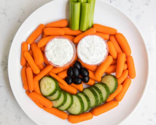 plate of veggies and dip in the shape of a pumpkin