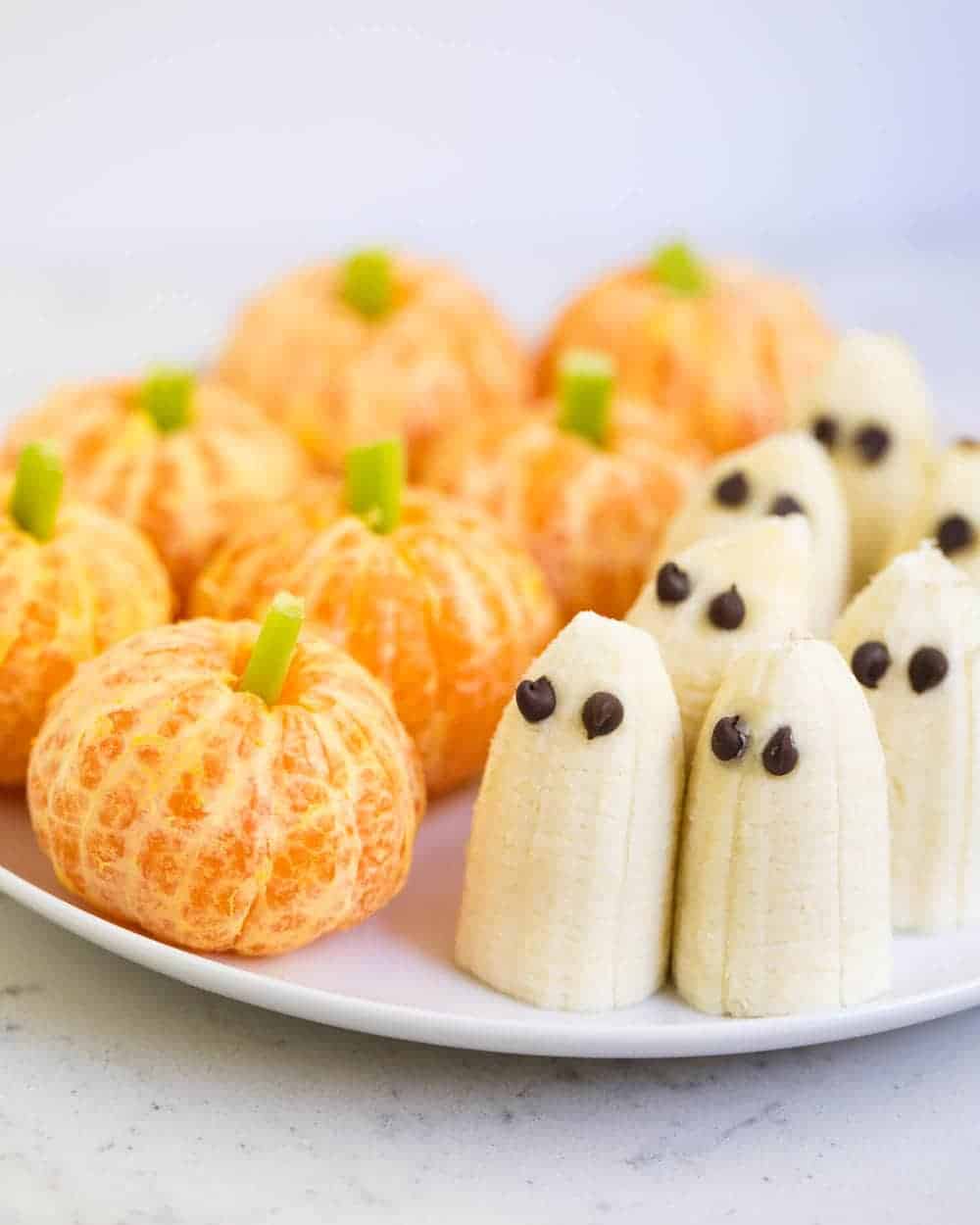 Mandarin oranges decorated like pumpkins and ghost bananas.