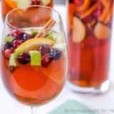 A glass of sangria with fresh fruit