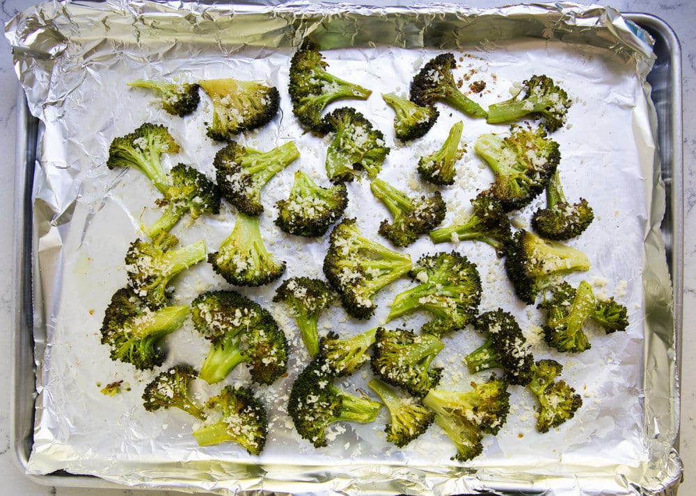 Parmesan broccoli on a baking sheet.