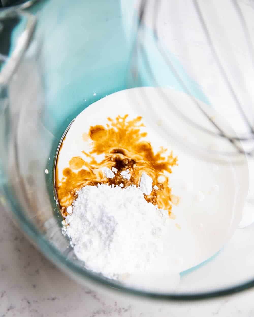 Whipped cream ingredients in a mixing bowl.