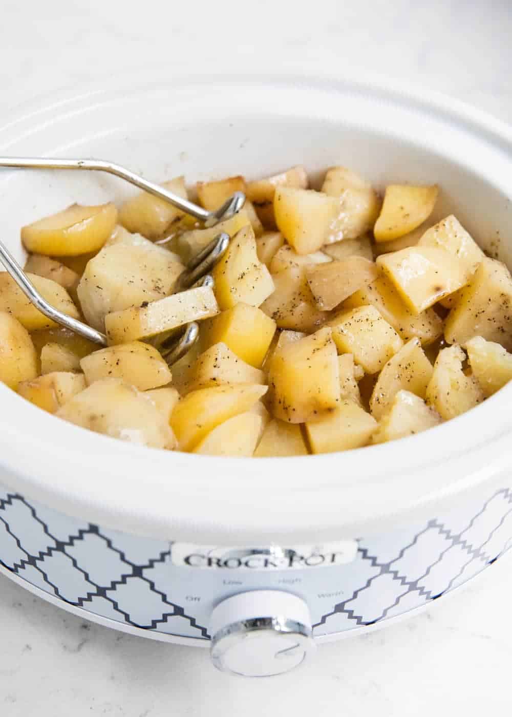 Mashing potatoes in the slow cooker.