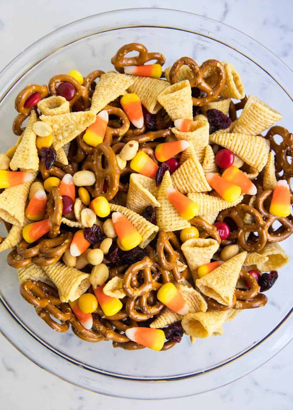 Thanksgiving chex mix in a glass bowl. 