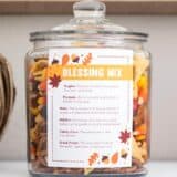 thanksgiving blessing mix in a glass container with a label
