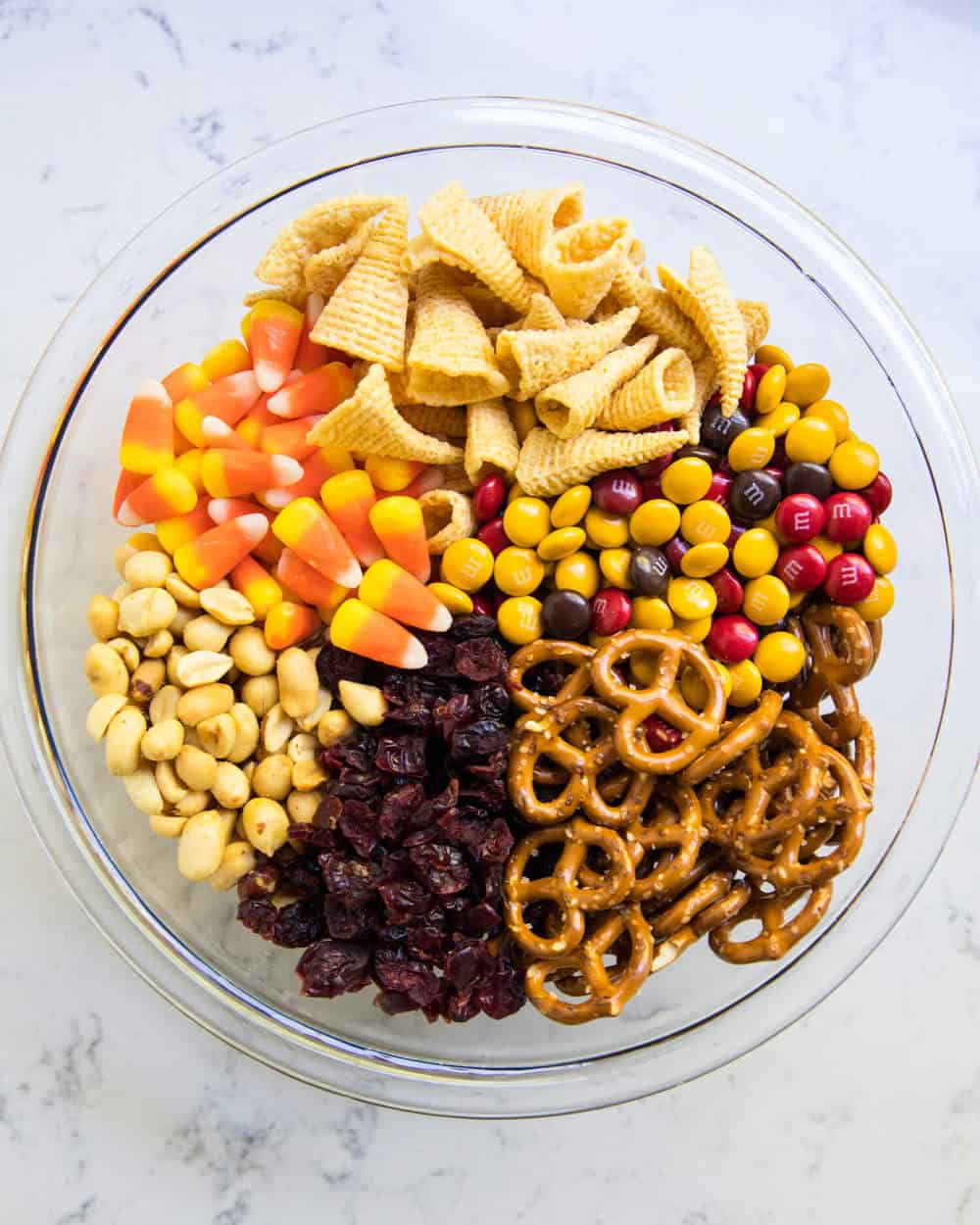 Candy corn trail mix in glass bowl.