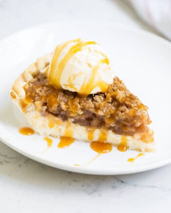 a piece of apple pie cheesecake on a white plate
